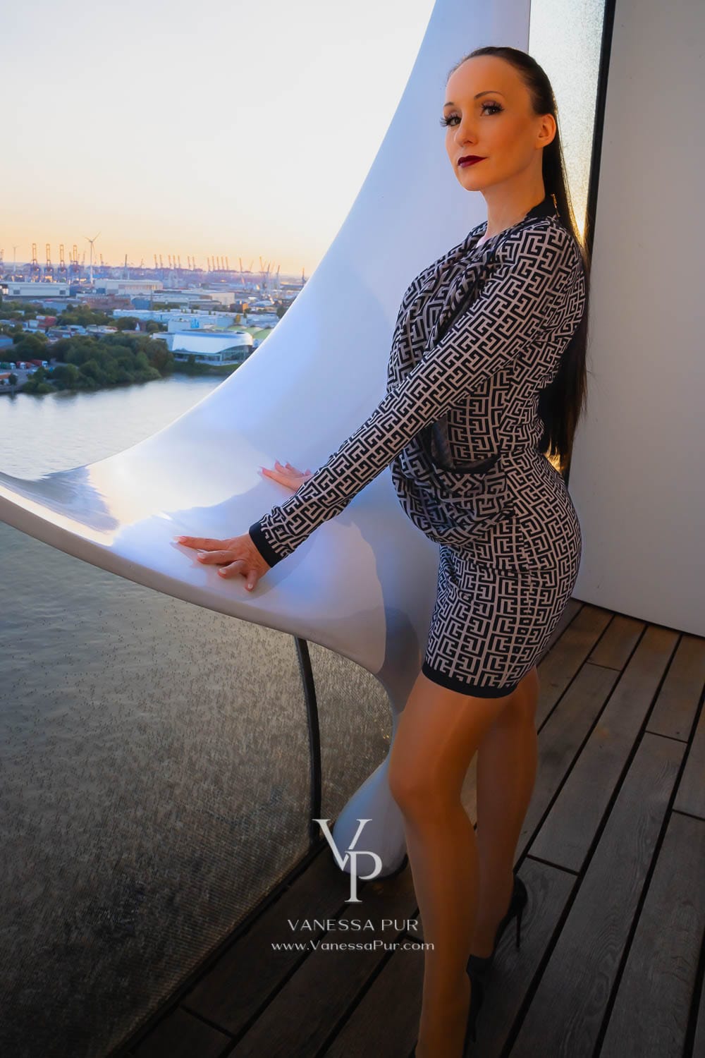 Vanessa Pur evening look with a luxurious Balmain mini dress with monogram and waterfall neckline, Wolford Neon 40 tights, and Christian Louboutin So Kate high heels